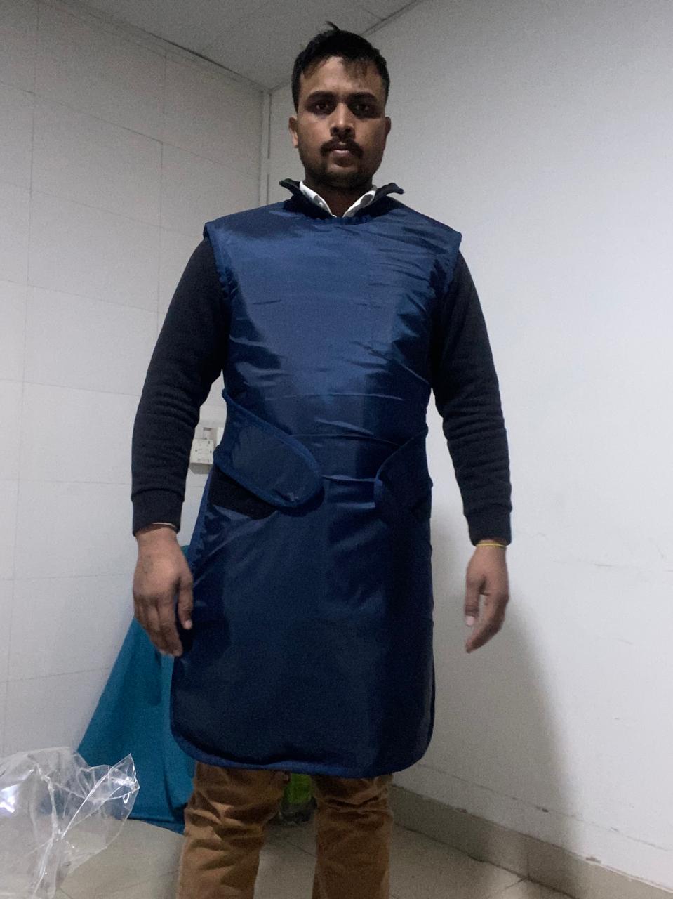Xtra Xray radiographer wearing a lead-lined apron before a home visit